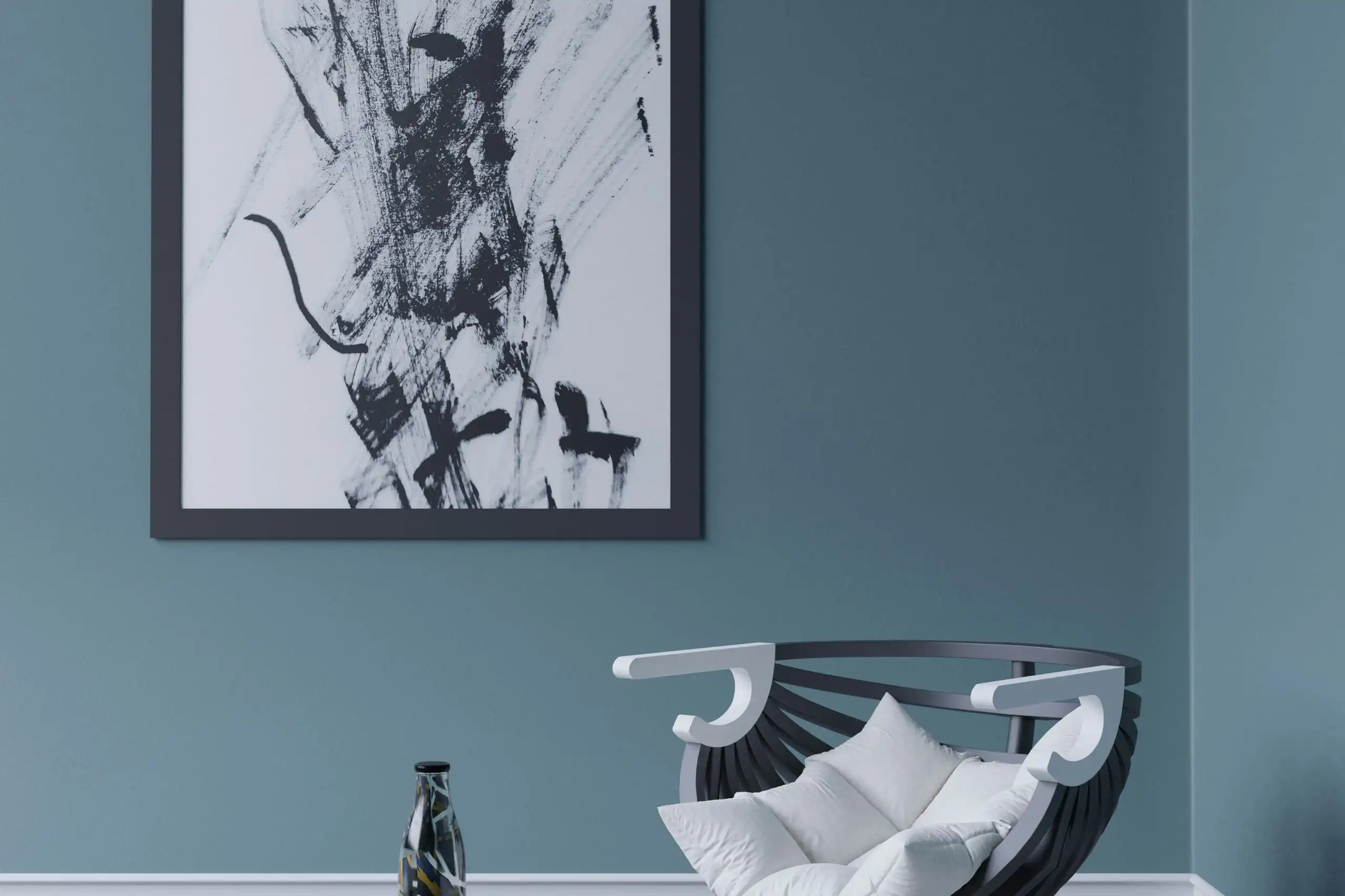 A blue-grey painted wall behind a white sculptural chair and a framed abstract print